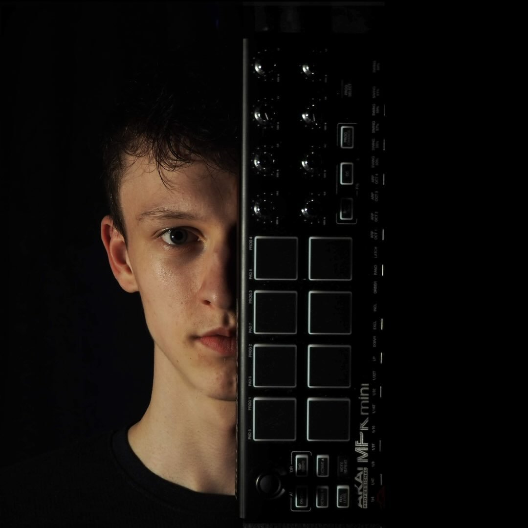 Jonezy, half his face hidden behind an Akai MPK mini controller